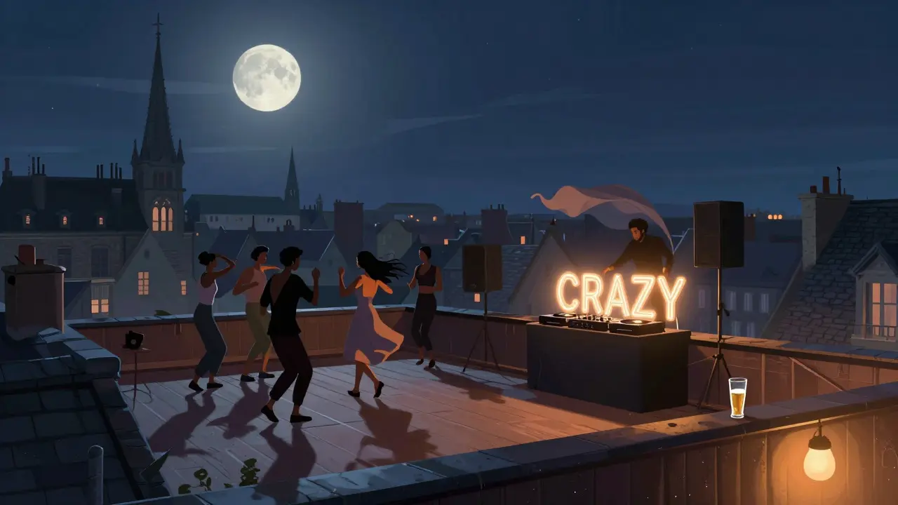 People dancing on a rooftop under a full moon with Caen's skyline behind them.